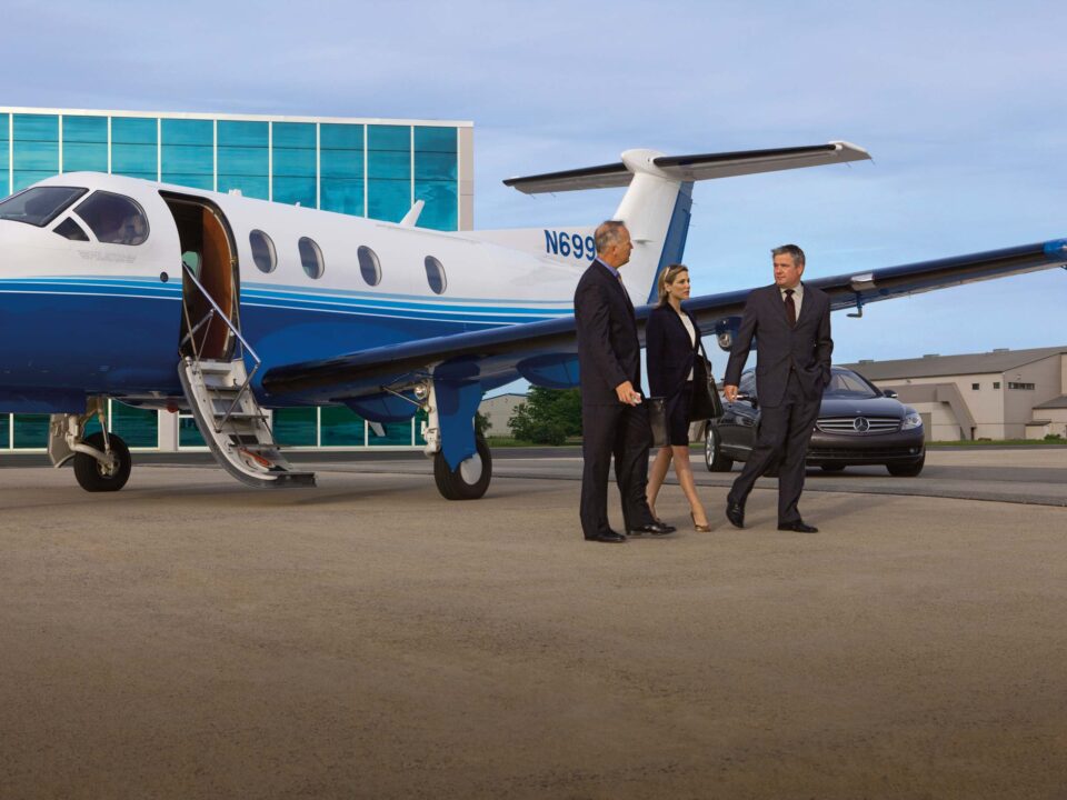 Pilots and flight staff standing near fractional jet ownership program aircraft